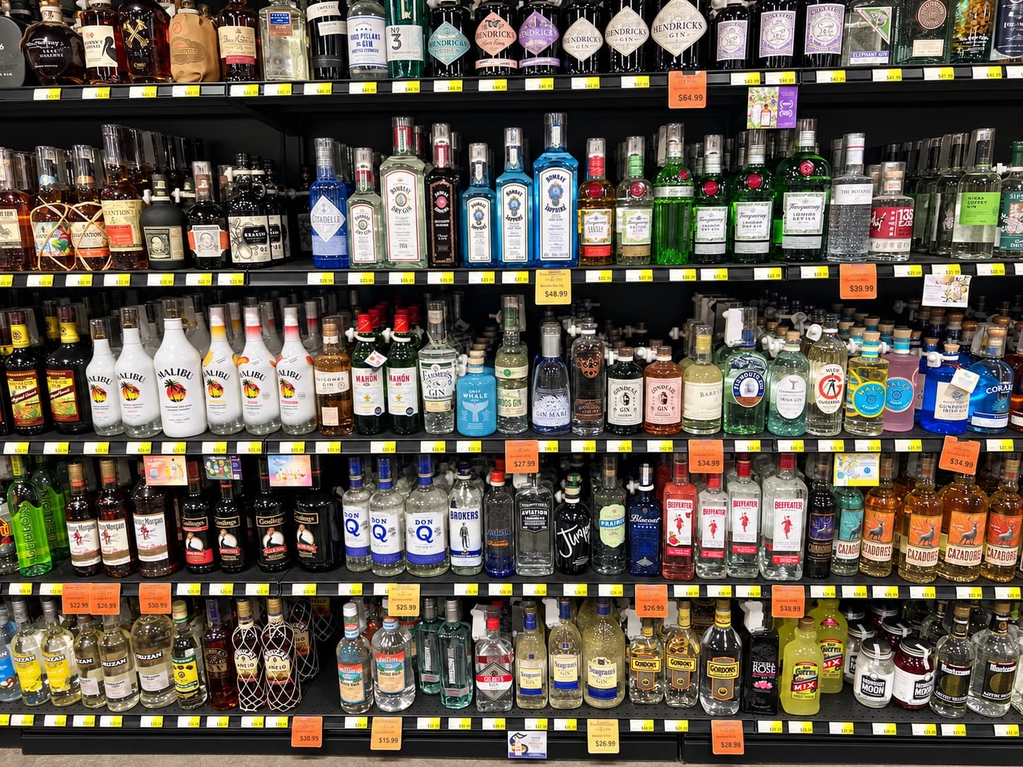 A colorful selection of gin and rum, from familiar favorites to distinctive craft bottles.